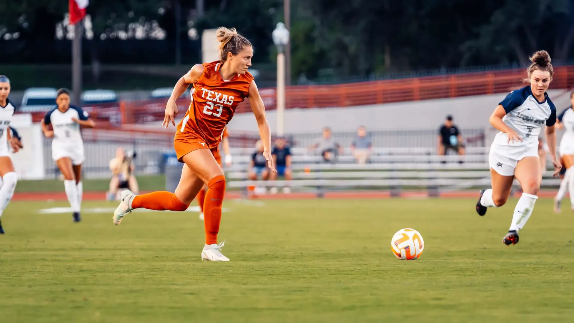 Texas Player Driving Forward Texas player number 23 in burnt orange kit driving the ball forward during a match