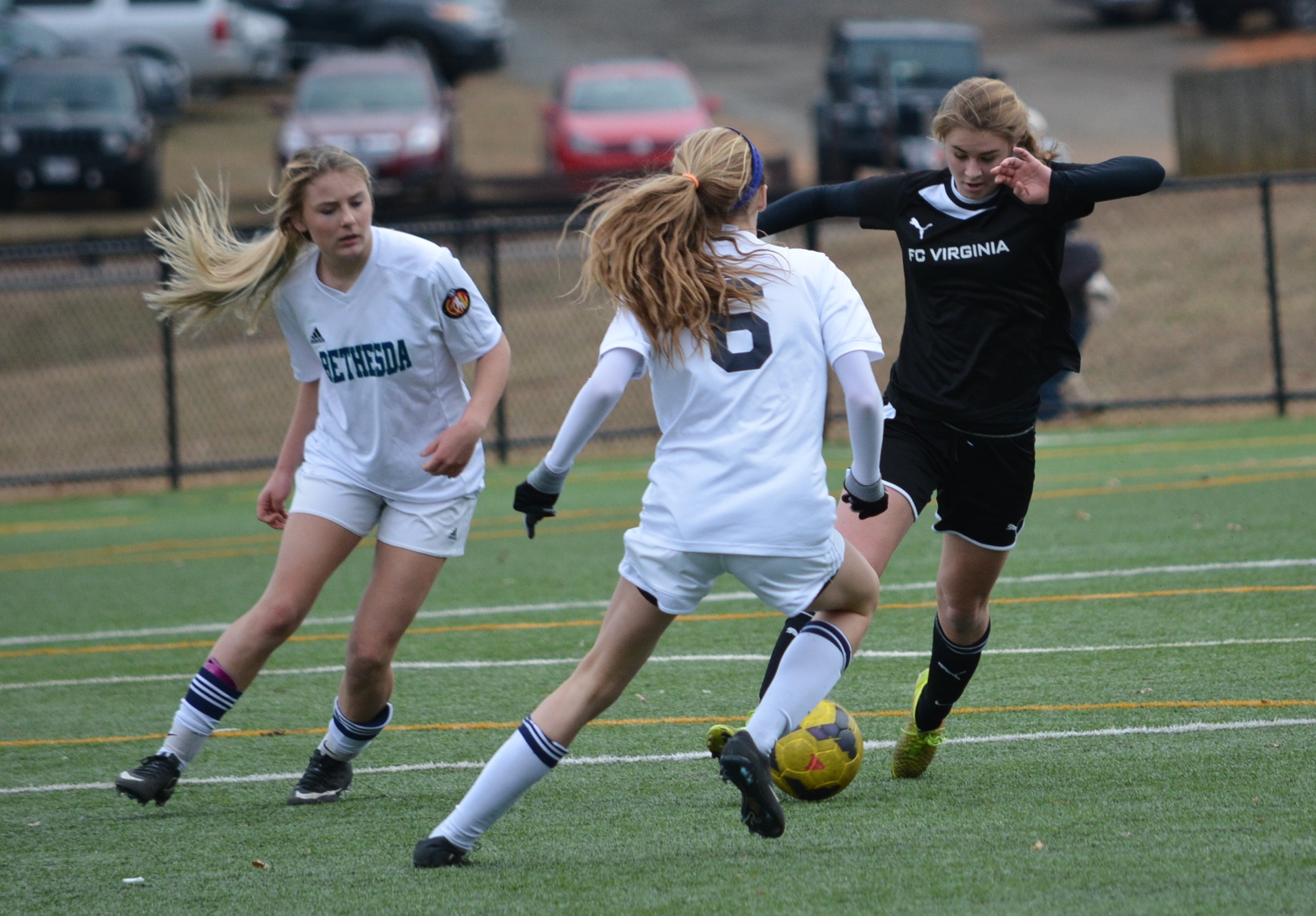 Players Battling For Ball Girls in FC Virginia black and Bethesda white kits competing for a yellow ball