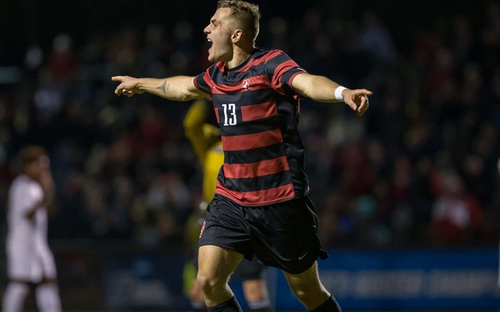 Stanford Player Celebrating Goal Stanford player number 13 in a red-and-black striped kit celebrates a goal with arms outstretched.