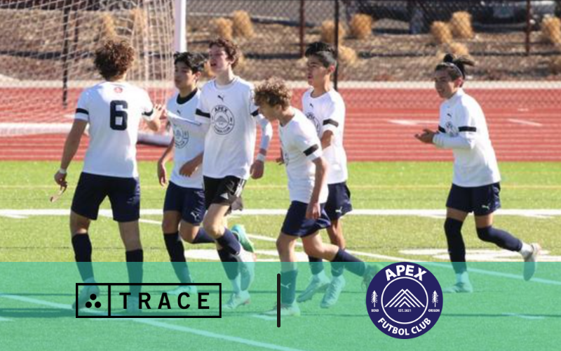Boys Soccer Team Celebrating Boys soccer team in white kits celebrating on turf; Trace and Apex Futbol Club logos