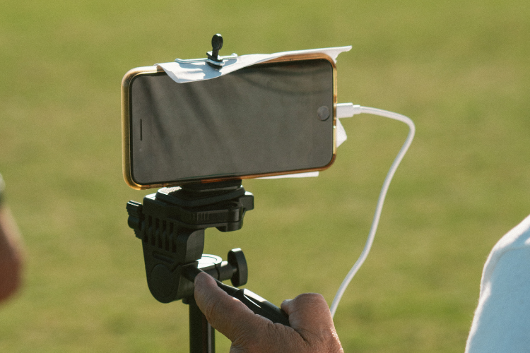 Parent recording a soccer game with a phone