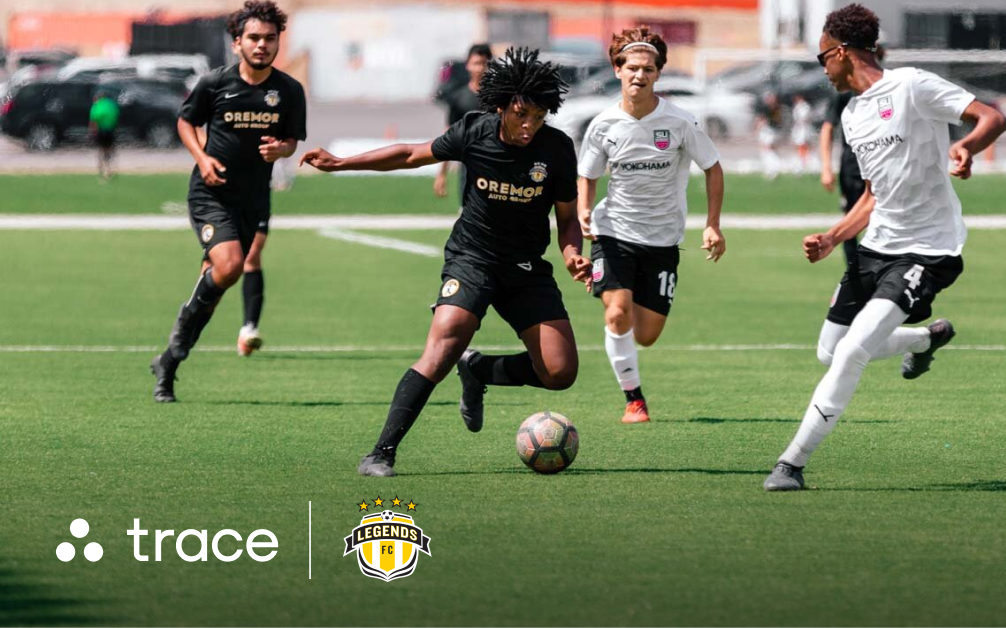 Legends FC Partnership Graphic Boy in a black kit dribbling past defenders in white during a match, with Trace and Legends FC logos below