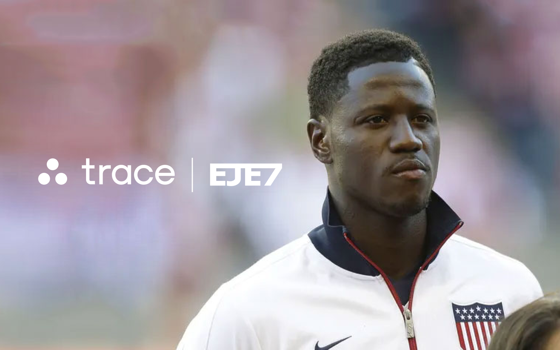 Eddie Johnson Joins Trace Soccer player in a white USA jacket beside the Trace and EJE7 logos