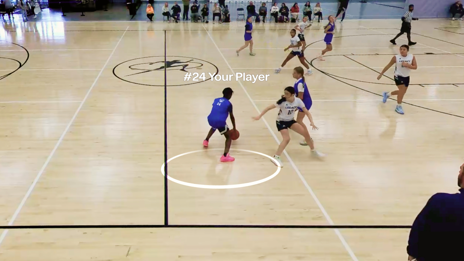Girls basketball game in a gym with a player dribbling, labeled #24 Your Player by Trace.
